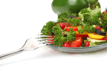 Wall Mural - Vegetable salad, plate and fork on white.