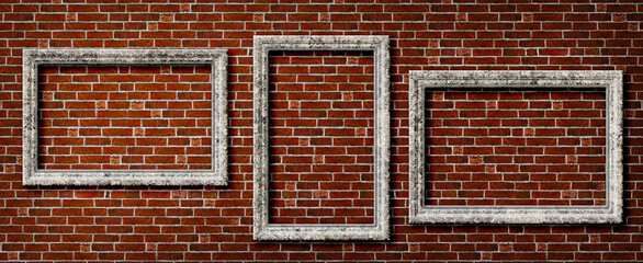 Three empty frames of beige marble on an old brick wall. Background texture with copy space