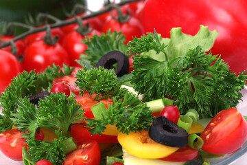 Wall Mural - Tomato, cucumber, olives, parsley in salad close-up.