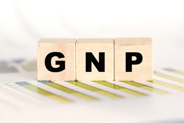 GNP word written on a wooden cubes. Can be used for business, marketing, financial concept. Selective focus.