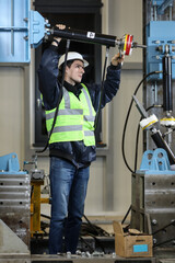 Wall Mural - Portrait of a Caucasian man , factory engineer in work clothes controlling the work process at the helicopter manufacture.