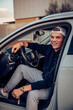 © Aitor Carrera Port√©/Westend61 - Smiling young man sitting in car