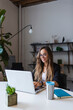 © Alexandra C. Ribeiro/Westend61 - Smiling businesswoman using laptop at desk in office