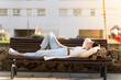 © VITTA GALLERY/Westend61 - Carefree businesswoman resting on bench during sunny day