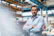 © Daniel Ingold/Westend61 - Male entrepreneur with arms crossed standing in industry