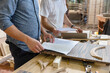 © Emma Innocenti/Westend61 - Employee checking design of furniture while standing at factory