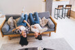 © BullRun - Cheerful friends chilling together on couch
