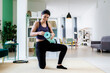 © Giorgio Fochesato/Westend61 - Young woman holding exercise mat while kneeling at home