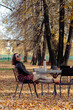 © Konstantin Trubavin/Westend61 - Woman wearing sunglasses while sitting in park on sunny day
