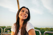 © alev/Westend61 - Smiling beautiful woman looking away while enjoying sunset from Ferris wheel