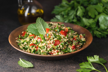 Wall Mural - Quinoa salad with parsley, cucumber and cherry tomatoes. Tabbouleh Traditional middle eastern or arab dish