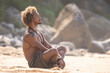 © SERGIO NIEVAS/Westend61 - Shirtless young man meditating at beach on sunny day