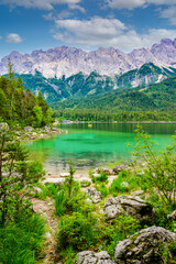  Eibsee lake with Zugspitze mountain in the background. Beautiful landscape scenery with paradise beach and clear blue water in German Alps - Garmisch Partenkirchen, Grainau - Bavaria, Germany, Europe.