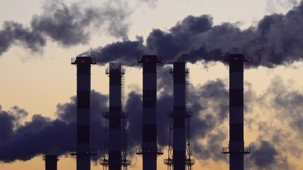 Wall Mural - industrial landscape, the pipes of the thermal power plant at sunset