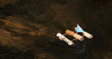 A Homemade Toy Sailing Raft Made From Wine Corks And Toothpicks Floats On A Bubbling Brook