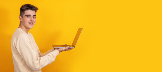 young man with laptop isolated on background