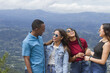 © Francis - group of four young Latin American adventurers friends three women one man outdoors talking laughing and joking using sunglasses nature in background in a summer day  ,mixed race persons joyfull
