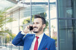 © busra - Cheerful businessman portrait of talkin in telephone.