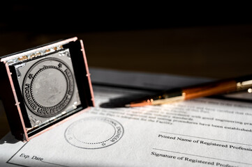 Selective focus on generic professional engineer, architecture. or surveyor stamp and certification statement