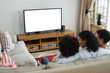 © Wavebreak Media - Mixed race lesbian couple and daughter sitting on couch watching tv