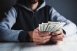 © Artvibe - man counts money calculating finance