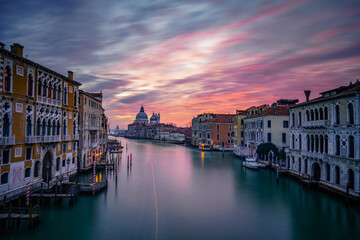 Wall Mural - Long exposure view of Grand Canal and Basilica Santa Maria della Salute at sunset in Venice, Italy