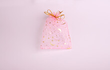 This Is A Beautiful Gift Of Transparent Pink And Gold Color Empty Voile Packing Bag On A Pink Background. Suitable For Packaging Jewelry, Cosmetics, Small Gifts And Surprises.