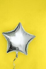 A silver glitter foil star shaped balloon