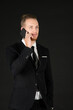 © Arunporn - Portrait of young smart confident and successful businessman in black suit using smartphone isolated on black background