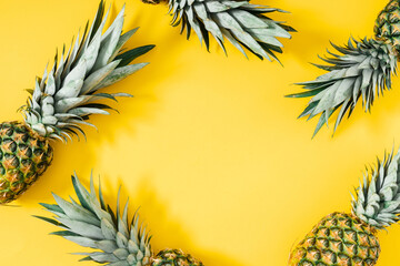 Wall Mural - Summer composition with pineapple. Ripe pineapple on yellow background. Flat lay, top view, copy space
