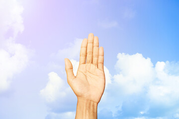 Young man hand showing refusal gesture behind of  blue sky and clouds background with copy space for wallpaper or banner