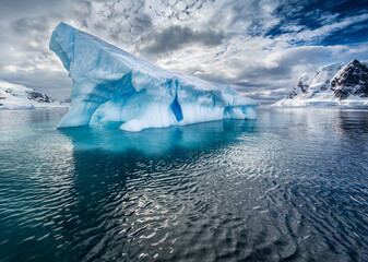 large iceberg broken off of glacier floats near antarctica