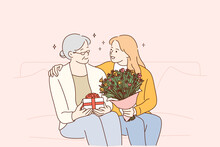 Mothers Day Holiday, Women In Family Concept. Beautiful Young Woman And Her Mother With Flowers And Present Box Sitting And Hugging At Home, Feeling Care And Love Vector Illustration