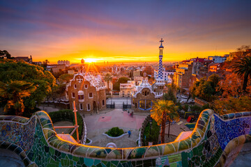 Wall Mural - Beautiful sunrise in Barcelona seen from Park Guell. Park was built from 1900 to 1914 and was officially opened as a public park in 1926. In 1984, UNESCO declared the park a World Heritage Site