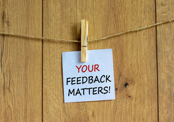Wall Mural - Your feedback matters symbol. White paper with text 'your feedback matters', clip on wood clothespin. Beautiful wooden background. Business and your feedback matters concept. Copy space.
