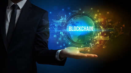 Elegant hand holding BLOCKCHAIN inscription, digital technology concept