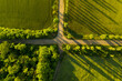 Beautiful aerial view of green fields and empty crossroad
