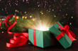 © New Africa - Beautiful Christmas gift box with magic light on table