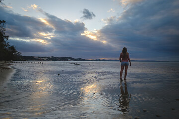 Wall Mural - a man walking on a beach