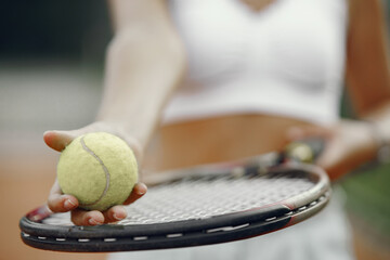 Wall Mural - Great day to play Cheerful young woman in t-shirt. Woman holding tennis racket and ball.