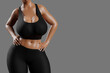 © PixlMakr - Young slim woman with big breasts in black sportswear