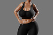 © PixlMakr - Young slim woman with big breasts in black sportswear