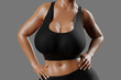 © PixlMakr - Young slim woman with big breasts in black sportswear
