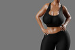 © PixlMakr - Young slim woman with big breasts in black sportswear