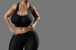 © PixlMakr - Young slim woman with big breasts in black sportswear