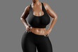 © PixlMakr - Young slim woman with big breasts in black sportswear