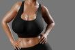© PixlMakr - Young slim woman with big breasts in black sportswear