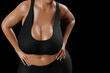 © PixlMakr - Young slim woman with big breasts in black sportswear