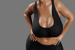 © PixlMakr - Young slim woman with big breasts in black sportswear