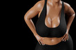 © PixlMakr - Young slim woman with big breasts in black sportswear